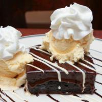 Giant Brownie A La Mode · Our rich housemade brownie with ganache inside and outside, warmed and topped with vanilla i...