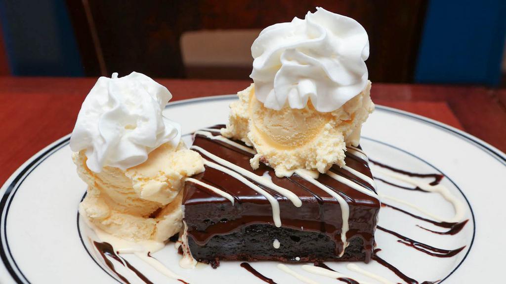 Giant Brownie A La Mode · Our rich housemade brownie with ganache inside and outside, warmed and topped with vanilla ice cream.