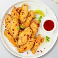 Sweet Spice Wings · Fresh chicken wings breaded, fried until golden brown, and tossed in sweet chili sauce. Serv...