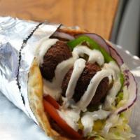 Falafel Wrap · Homemade freshly fried falafel wrapped in pita seasoned to perfection with your choice of to...