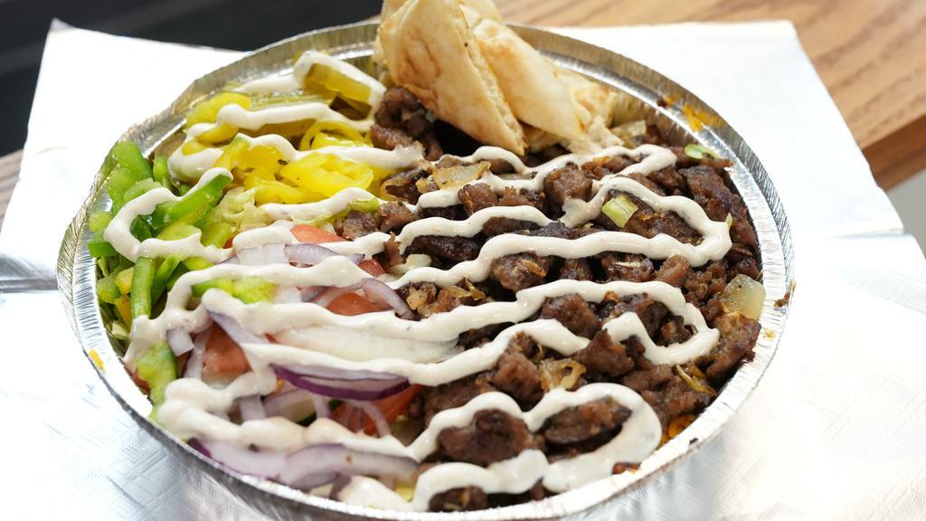 Lamb Platter · Grilled lamb cut from the gyro seasoned to perfection with your choice of toppings served over rice or fries.