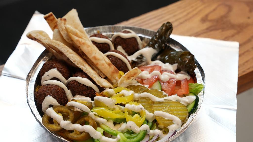 Falafel Platter · Fried falafel seasoned to perfection with your choice of toppings served over rice or fries.