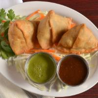 Samosa 2Pc · Triangular turnovers filled with potatoes and green peas, Indian spices, served with mint an...
