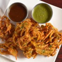 Mix Veg Pakora · An array of mixed vegetable fritters served with tangy tamarind sauce.