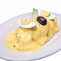 Papa A La Huancaina · Sliced Potato smothered in yellow pepper cheese sauce. Served with olive and sliced hard boi...