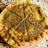 Zaatar Bread · Pita topped with extra virgin olive oil, thyme and herb seasoning.