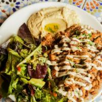 Chicken Shawarma Platter · Slices of marinated chicken from the rotisserie. Served with rice, green salad and pita brea...