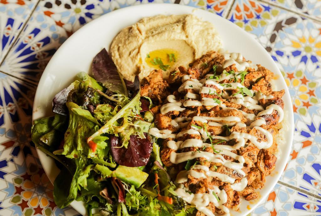 Chicken Shawarma Platter · Slices of marinated chicken from the rotisserie. Served with rice, green salad and pita bread with your choice of hummus or babghanouj.