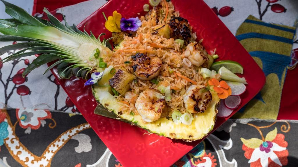 Pineapple Fried Rice · Stir-fried jasmine rice with egg, onions, pineapple, scallions, tomatoes & carrots.
