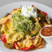 Nachos · Corn Tortilla Chips, House Cheese Sauce, Guacamole, Sour Cream, Pico de Gallo, Jalapenos. **...