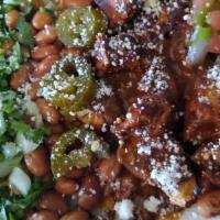 Holy Mole · Chicken in a mole sauce, cilantro red rice, pinto beans, sour cream, cotija cheese, cilantro...