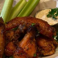 Tamarind Chicken Wings · 7 wings fried and coated with a sweet and tangy Tamarind Sauce. Served with a Side of Ranch.