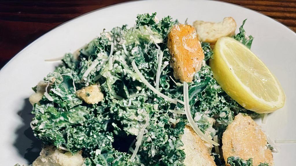 Kale Caesar Salad · Marinated kale, Caesar dressing, Shaved Parmesan, Lemon, & Seasoned House Croutons