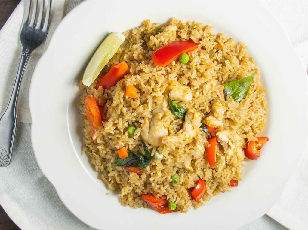 Green Curry Fried Rice (Spicy) · Fried rice in a spicy green curry sauce sautéed with pea and carrot, bell peppers, basil, and a choice of meat.