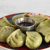 Veg Dumplings (8 Pc) · Handmade dumplings with veggie filling in a spinach and flour shell.  Served with our homema...