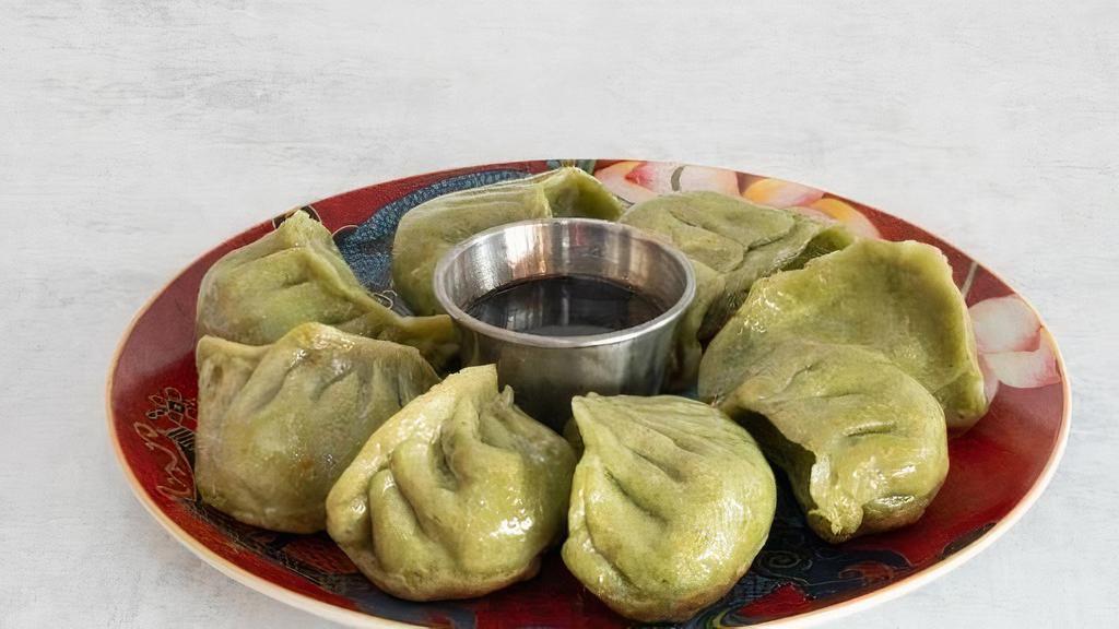 Veg Dumplings (8 Pc) · Handmade dumplings with veggie filling in a spinach and flour shell.  Served with our homemade dumpling sauce.