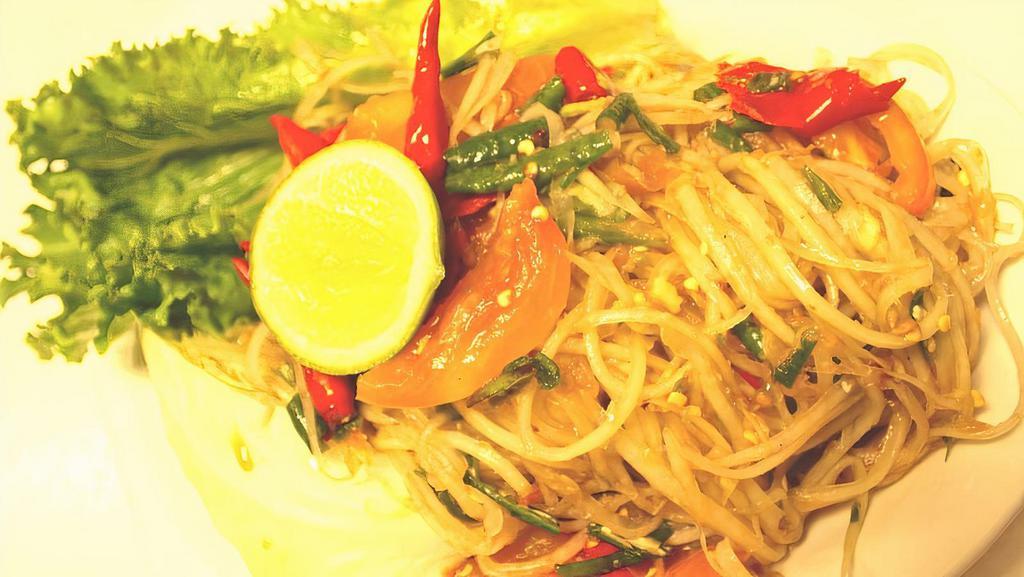 Green Papaya Salad · Green papaya, freshly squeezed lime juice, tomatoes, fish sauce, and chili pepper (optional). Served with lettuce and crunchy cabbage.