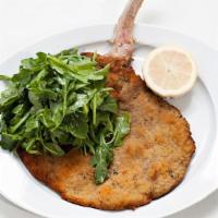 Veal Chop Milanese · Topped with a light arugula salad.