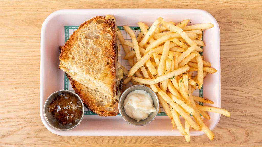 Parisian Grilled Cheese. · Brie & melted leeks on toasted sourdough with a side of fig jam