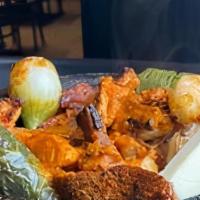 Guacamole En Molcajete · Avocado, tomato, onions, jalapenos, cilantro, served with tortilla chips.