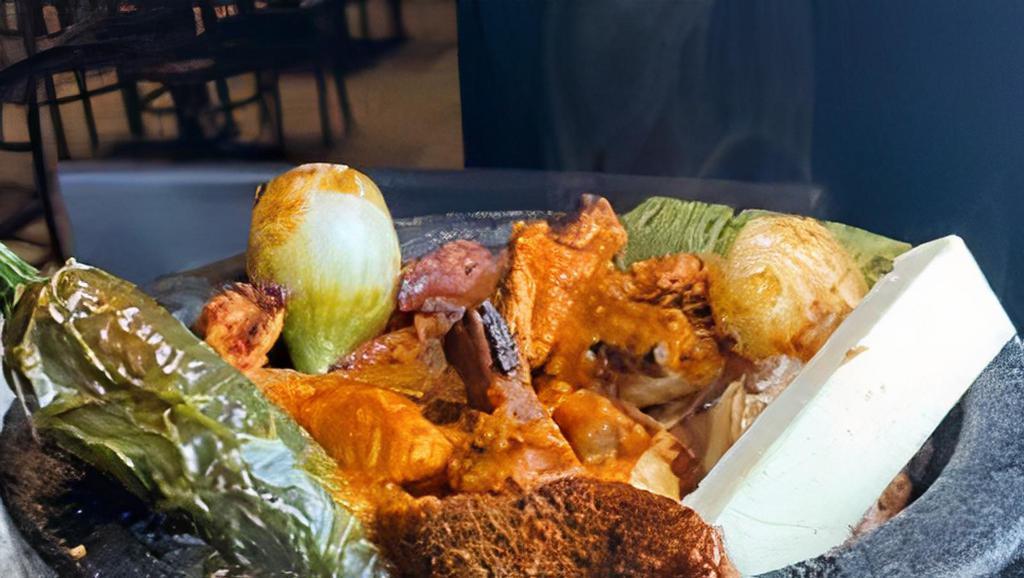 Guacamole En Molcajete · Avocado, tomato, onions, jalapenos, cilantro, served with tortilla chips.