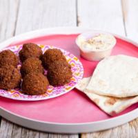 Falafel · Warm falafel, served in naan, and with a spread of hummus. Mixed with tomato, lettuce and on...