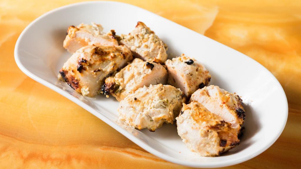 Chicken Malai Kabab · Slices of boneless chicken marinated (white) with cream cheese and Indian spice.
