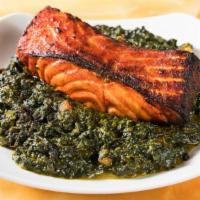 Salmon Fish Tandoori · Slices of salmon fish with fresh spinach.
