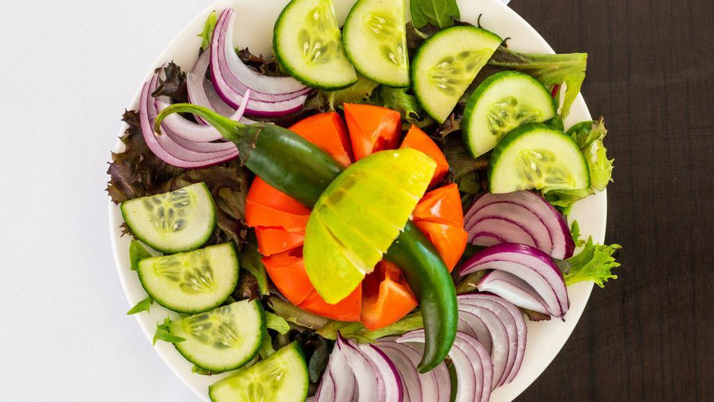 Green Salad · Indian salad of cucumber, tomatoes, onion, carrots, Bell pepper, and lettuce.