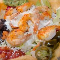 Shrimp Nacho · With guacamole, melted cheese, sour cream, fresh cheese, beans, onions cilantro, tomato, and...