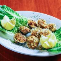Baked Clams · Minced clams mixed with butter, onions, parsley and bread crumbs, stuffed into a half clam s...