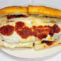 Veal Cutlet Parmigiana Hero · Thin veal cutlets, lightly breaded and fried, served on a hot hero roll with tomato sauce an...