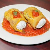 Eggplant Rollatine · Fresh slices of eggplant, rolled with ricotta cheese, covered in tomato sauce and baked.