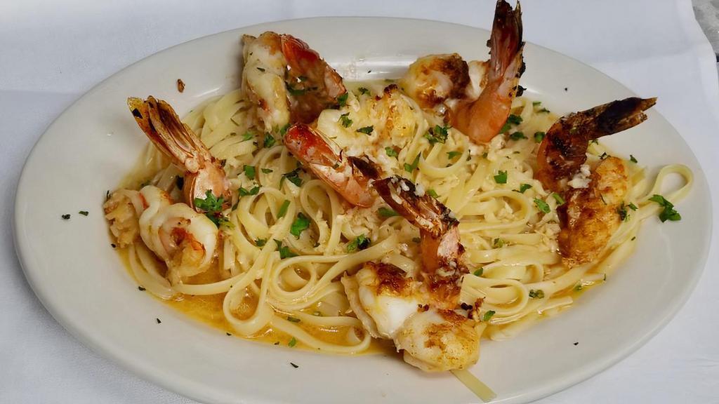 Shrimp Scampi · Jumbo shrimp sauteed with butter, garlic and parsley. Served with choice of pasta or salad. 

Note: Shrimp can be served on top of pasta or pasta on the side. Photo shows shrimp over pasta.