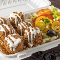 Falafel Over Rice · Served over basmati brown rice  with choice of salad, sauce, and pita. Choose up to 3 sauces...