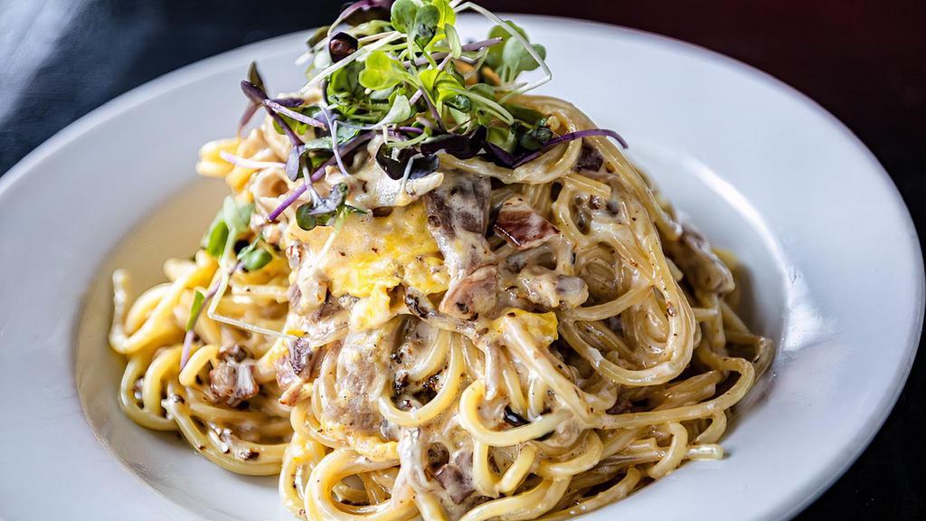 Spaghetti Carbonara · Crispy pancetta, caramelized onions, parmigiana, cracked pepper and egg.