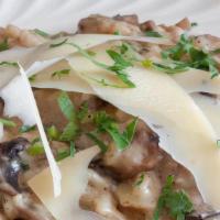 Mushrooms & Truffle Oil Risotto · Porcini and cremini and mushrooms with shaved parmigiana.