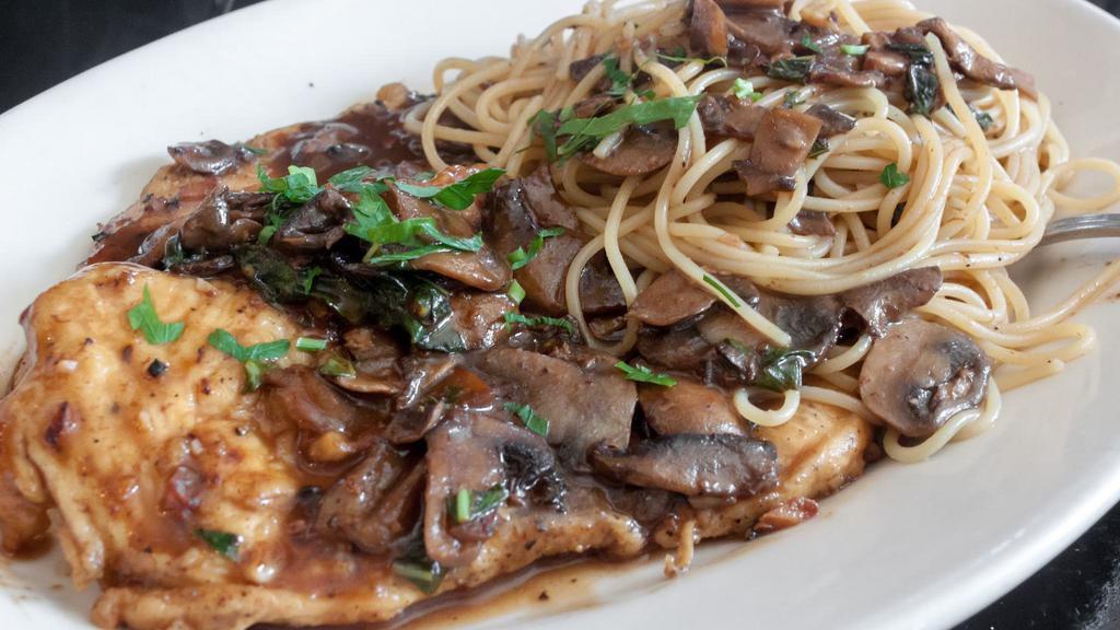 Chicken Marsala · Sauteed chicken breasts with a marsala wine and mushroom sauce and served on a bed of linguine.
