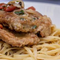 Veal Francese · Lightly egg battered veal scallopini with a lemon, garlic white wine sauce and served on a b...