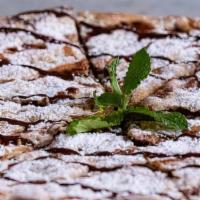 Nutella Pizza · Double crusted pizza stuffed with Nutella and topped with powdered sugar and fresh raspberry...