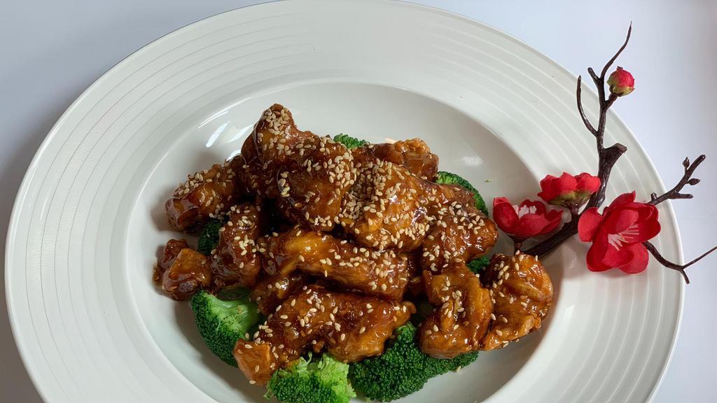 Sesame Chicken (With Rice) · Crispy white meat chicken with broccoli in brown sauce.