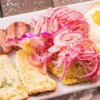 Tres Golpes · Fried salami, fried eggs, fried cheese and mashed plantain topped with fried onions