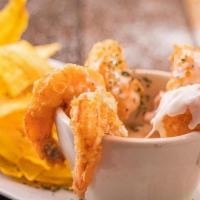 Coconut Shrimp · Crispy shrimps in coconut sauce, accompanied with chip plantains