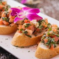 Bruschettas · Toasted garlic bread topped with marinated tomatoes diced in olive oil and basil