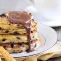 Chocolate Chip Buttermilk Pancakes · 3 perfectly fluffy chocolate chip pancakes served with a side of butter and syrup.