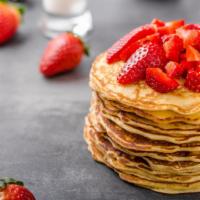 Strawberry Buttermilk Pancakes · 3 perfectly fluffy strawberry pancakes served with a side of butter and syrup.