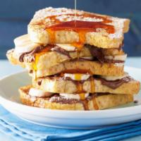 Strawberry French Toast · Sliced challah bread soaked in eggs and milk, then fried and topped with strawberries served...