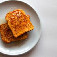 Original French Toast · Sliced challah bread soaked in eggs and milk, then fried served with a side of butter and sy...
