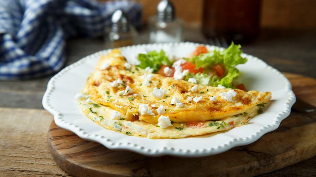 Greek Omelette · Fresh eggs, tomatoes, onions, and feta cheese. Served with a side of home fries and hot toast.