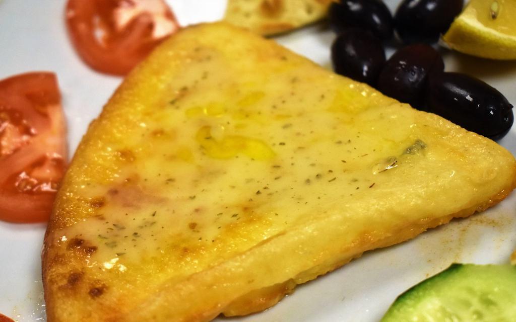 Cheese Saganaki · Oven roasted graviera cheese with lemon and olive oil.